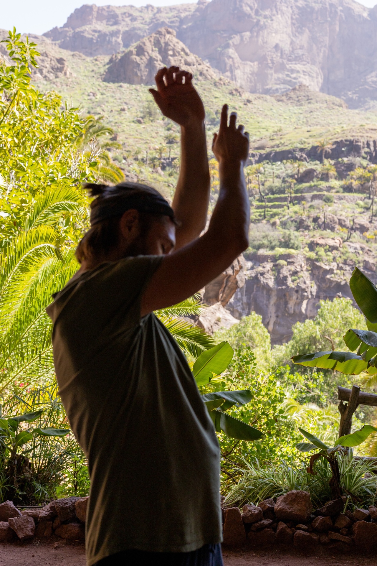 Oliver mit erhobenen Armen vor Berglandschaft